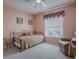 Cozy bedroom with daybed, chair, and window at 33236 Grand Cypress Way, Leesburg, FL 34748
