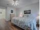 Spacious bedroom with wood floors and ceiling fan at 33236 Grand Cypress Way, Leesburg, FL 34748