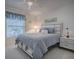 Bright bedroom with a queen-size bed and ceiling fan at 33236 Grand Cypress Way, Leesburg, FL 34748