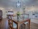 Dining area with wooden table and chairs, open to living room and kitchen at 33236 Grand Cypress Way, Leesburg, FL 34748