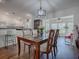 Bright dining area with glass-top table and four chairs, adjacent to kitchen and sunroom at 33236 Grand Cypress Way, Leesburg, FL 34748