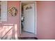 Open white front door offering a glimpse into the home's interior at 33236 Grand Cypress Way, Leesburg, FL 34748