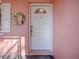 White front door accented with a sunflower wreath, and a window above at 33236 Grand Cypress Way, Leesburg, FL 34748