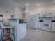 Kitchen boasts white cabinets, granite countertops, and modern appliances at 33236 Grand Cypress Way, Leesburg, FL 34748