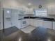Kitchen with white cabinets, granite countertops and stainless steel appliances at 33236 Grand Cypress Way, Leesburg, FL 34748