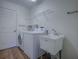 Laundry room with washer, dryer, and utility sink at 33236 Grand Cypress Way, Leesburg, FL 34748