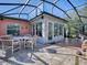 Spacious screened patio with tile floor and seating area at 33236 Grand Cypress Way, Leesburg, FL 34748