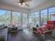 Bright sunroom with plenty of windows and comfortable seating at 33236 Grand Cypress Way, Leesburg, FL 34748