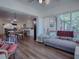 Sunroom with comfy couch and ample natural light, overlooking backyard at 33236 Grand Cypress Way, Leesburg, FL 34748