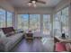Sunroom features a relaxing couch and easy access to the outdoors at 33236 Grand Cypress Way, Leesburg, FL 34748