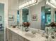 Bathroom with double sinks and a large vanity mirror at 4002 Coachshire Way, Mount Dora, FL 32757