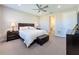 Bright bedroom with king-size bed and en-suite bathroom access at 409 Alcove Dr, Groveland, FL 34736