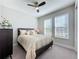 Bright bedroom with ceiling fan and en-suite bathroom at 409 Alcove Dr, Groveland, FL 34736