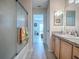 Bathroom with a shower/tub combo and view into the living room at 409 Rose Croft Ter, The Villages, FL 32162