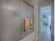 Bathroom with a shower/tub combo and view into the living room at 409 Rose Croft Ter, The Villages, FL 32162