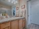 Bathroom with wood cabinets, granite countertop, and shower/tub combo at 409 Rose Croft Ter, The Villages, FL 32162