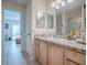 Bathroom with wood cabinets and granite countertops at 409 Rose Croft Ter, The Villages, FL 32162