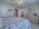 Bedroom with a queen bed, dresser, and view of the dining area at 409 Rose Croft Ter, The Villages, FL 32162