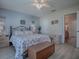Bright bedroom with a queen-size bed and ensuite bathroom access at 409 Rose Croft Ter, The Villages, FL 32162