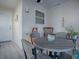 Bright dining area with round table and four chairs, situated near a sunroom at 409 Rose Croft Ter, The Villages, FL 32162