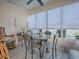 Bright dining area with round table and four chairs, situated near a sunroom at 409 Rose Croft Ter, The Villages, FL 32162