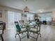 Casual dining area with round glass table and four chairs, located in living area at 409 Rose Croft Ter, The Villages, FL 32162