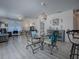 Casual dining area with round glass table and four chairs, located in living area at 409 Rose Croft Ter, The Villages, FL 32162