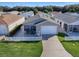 Tan house with white picket fence and driveway at 409 Rose Croft Ter, The Villages, FL 32162
