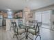 Bright kitchen with stainless steel appliances and adjacent dining area with glass table at 409 Rose Croft Ter, The Villages, FL 32162