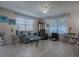 Living room with gray couch, glass coffee table, and wood accent table at 409 Rose Croft Ter, The Villages, FL 32162