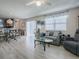 Relaxing living room with gray couch and glass-top coffee table at 409 Rose Croft Ter, The Villages, FL 32162