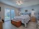 Main bedroom with sliding glass door to backyard and ceiling fan at 409 Rose Croft Ter, The Villages, FL 32162