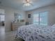 Main bedroom with dresser, sliding glass doors and ceiling fan at 409 Rose Croft Ter, The Villages, FL 32162