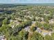Aerial view of a residential neighborhood showcasing numerous houses nestled amongst lush greenery at 4626 Ne 7Th St, Ocala, FL 34470