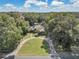 Spacious home with a large yard and circular driveway, surrounded by trees at 4626 Ne 7Th St, Ocala, FL 34470