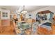 Elegant dining room with glass table and hardwood floors at 4626 Ne 7Th St, Ocala, FL 34470