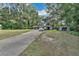 Long driveway leading to a house with detached garage and shed at 4626 Ne 7Th St, Ocala, FL 34470