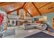 Living room with vaulted wood ceilings and a large sectional sofa at 4626 Ne 7Th St, Ocala, FL 34470