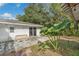 Small patio area with large plants next to the house at 4626 Ne 7Th St, Ocala, FL 34470