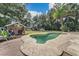 Kidney-shaped pool with surrounding deck and lush landscaping at 4626 Ne 7Th St, Ocala, FL 34470