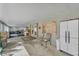 Spacious screened porch with seating area, storage, and artwork at 4626 Ne 7Th St, Ocala, FL 34470