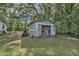 Detached storage shed with double doors and various items inside at 4626 Ne 7Th St, Ocala, FL 34470