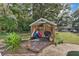 Wooden storage shed with various items stored inside at 4626 Ne 7Th St, Ocala, FL 34470