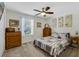 Bedroom with a dresser, queen bed, and carpeted floor at 4809 Magnetite Loop, Mount Dora, FL 32757