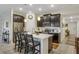 Modern kitchen with dark cabinetry, quartz countertops, and an island at 4809 Magnetite Loop, Mount Dora, FL 32757