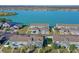Aerial view of townhouses and single Gathering homes near a lake at 561 Juniper Springs Dr, Groveland, FL 34736