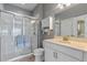 Modern bathroom with a walk-in shower, white vanity, and updated fixtures at 561 Juniper Springs Dr, Groveland, FL 34736