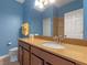 Bathroom with double vanity, neutral color palette, and updated fixtures at 561 Juniper Springs Dr, Groveland, FL 34736
