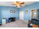 Bright bedroom with a desk, double closet, and carpeted floor at 561 Juniper Springs Dr, Groveland, FL 34736