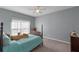 Cozy bedroom with a double bed, plush bedding, and plenty of natural light at 561 Juniper Springs Dr, Groveland, FL 34736